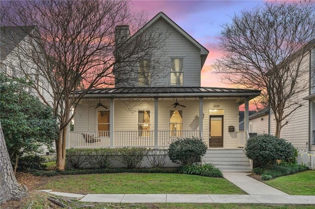 view of front of property with a porch and a front yard