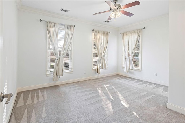 spare room featuring crown molding, ceiling fan, and light carpet