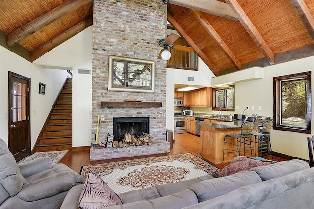 15082 Old Farms Rd, Folsom, LA 70437 - living room featuring sink, ceiling fan, a fireplace, light hardwood / wood-style floors, and wooden ceiling