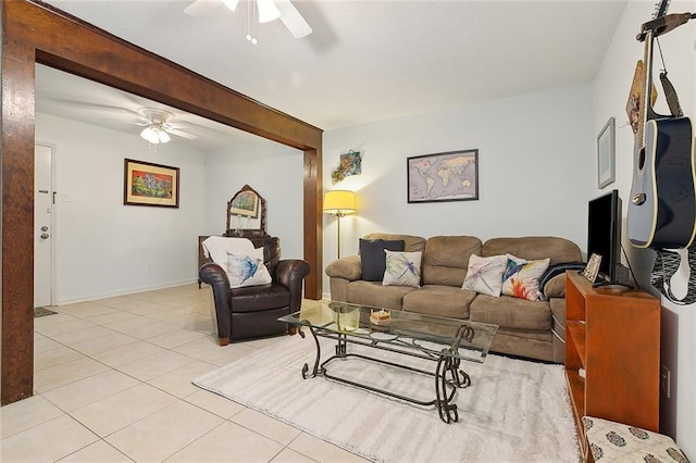 tiled living room featuring beam ceiling and ceiling fan