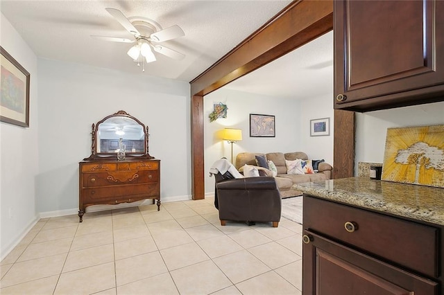 tiled living room featuring ceiling fan