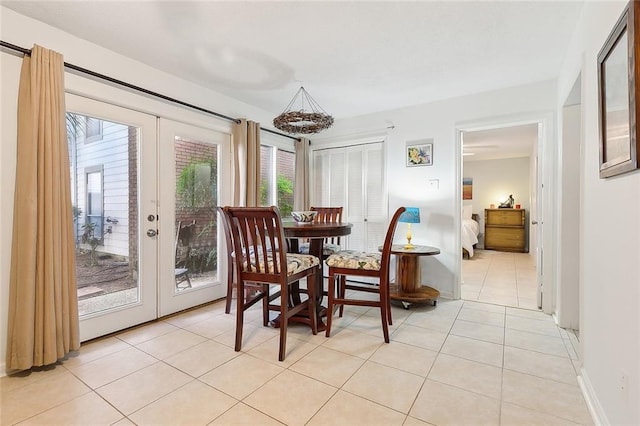 tiled dining area featuring plenty of natural light and french doors