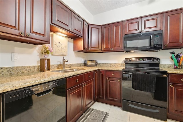 kitchen with sink, light tile patterned floors, light stone counters, black appliances, and a textured ceiling