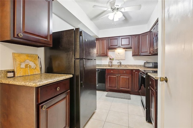 kitchen featuring light stone countertops, sink, light tile patterned floors, and black appliances