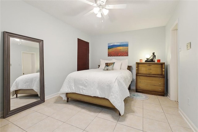 tiled bedroom featuring ceiling fan