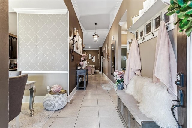 mudroom with crown molding and light tile patterned floors