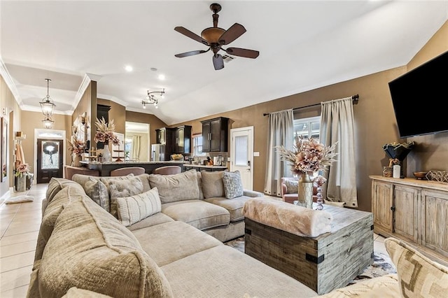 living room featuring crown molding, ceiling fan, light tile patterned flooring, and vaulted ceiling