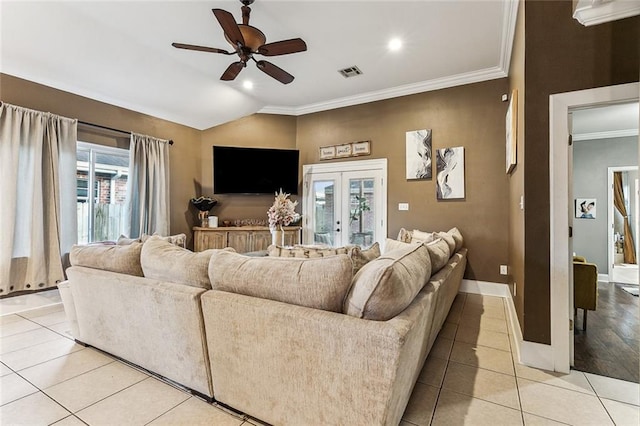 living room featuring french doors, lofted ceiling, light tile patterned floors, ornamental molding, and ceiling fan