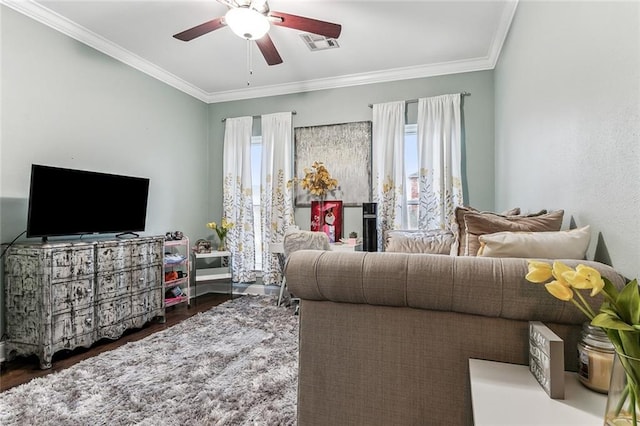 living room featuring crown molding, plenty of natural light, and dark hardwood / wood-style floors