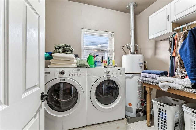 washroom with cabinets, gas water heater, and separate washer and dryer