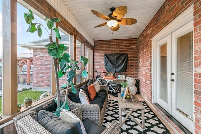 sunroom / solarium featuring french doors, ceiling fan, and a wealth of natural light