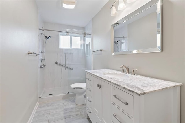 bathroom with vanity, toilet, and a tile shower