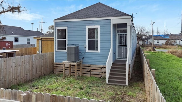 back of house with a lawn