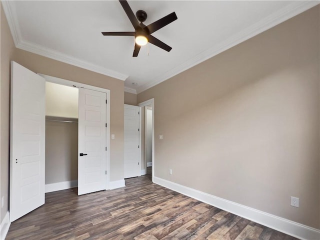 unfurnished bedroom featuring ceiling fan, ornamental molding, dark hardwood / wood-style flooring, and a closet