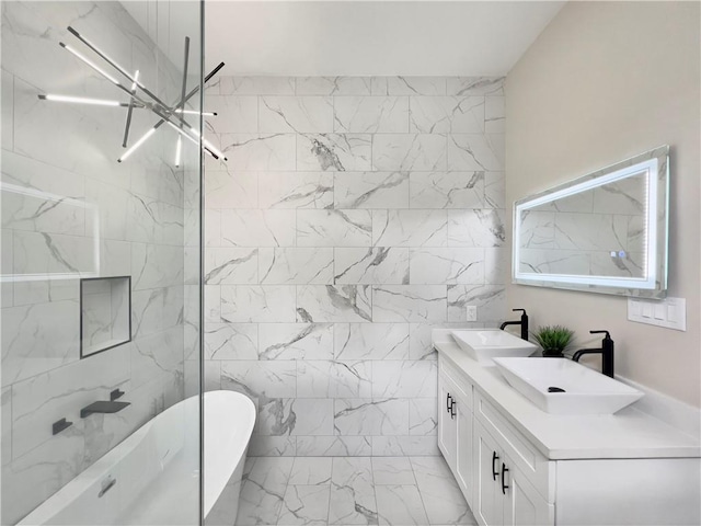 bathroom featuring vanity, a tub, and tile walls