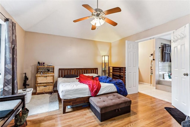 bedroom with hardwood / wood-style floors, ensuite bath, and ceiling fan