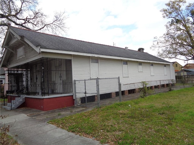 view of side of home featuring a lawn