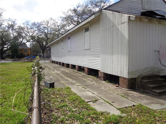 view of side of home featuring a yard