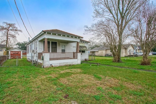 back of property featuring a porch and a lawn