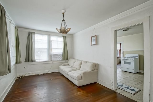 living area featuring hardwood / wood-style floors and a notable chandelier