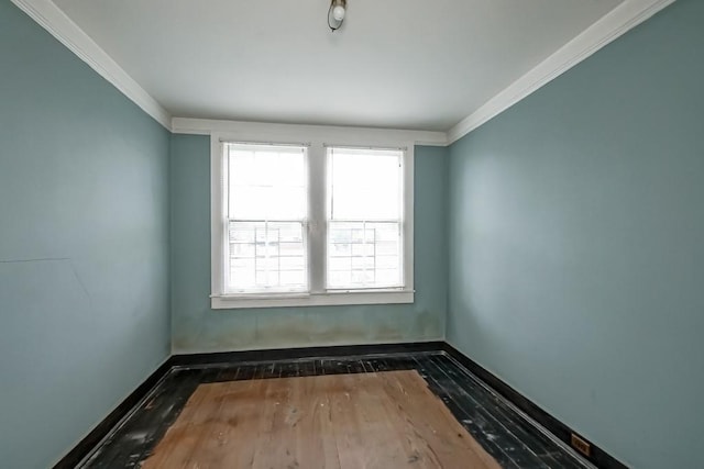 spare room with crown molding and dark hardwood / wood-style floors