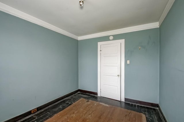 empty room featuring crown molding and dark hardwood / wood-style flooring