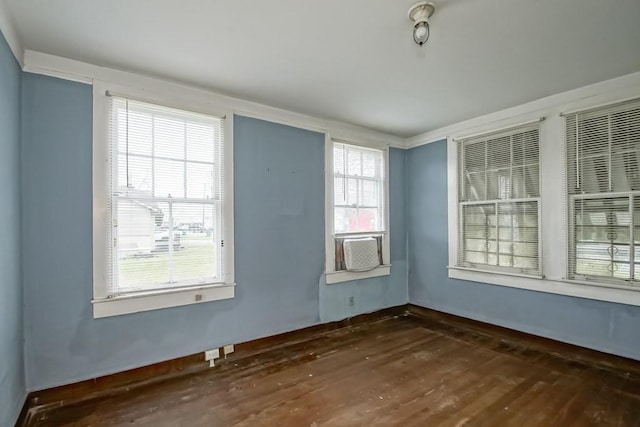 unfurnished room with dark hardwood / wood-style flooring