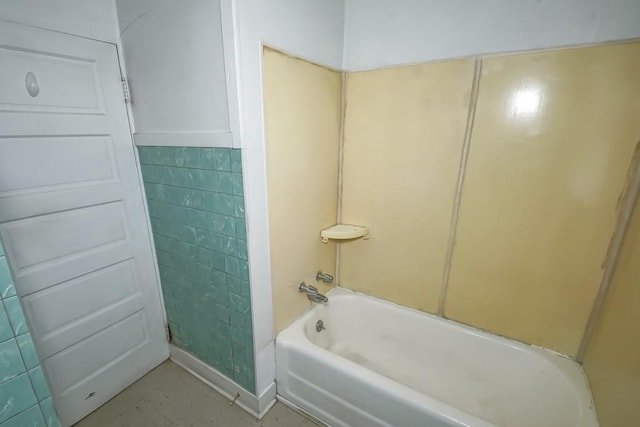 bathroom featuring bathtub / shower combination and tile walls