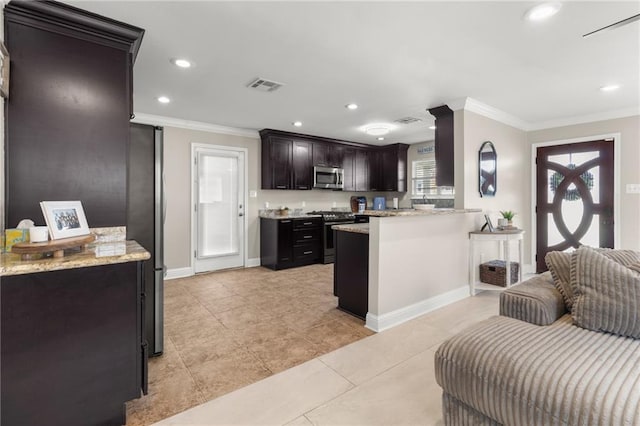 kitchen with light stone countertops, a wealth of natural light, ornamental molding, and stainless steel appliances