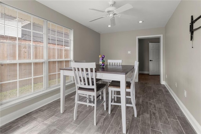 dining room with a barn door and ceiling fan