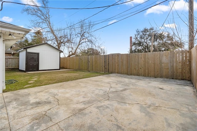 view of yard with a shed and a patio