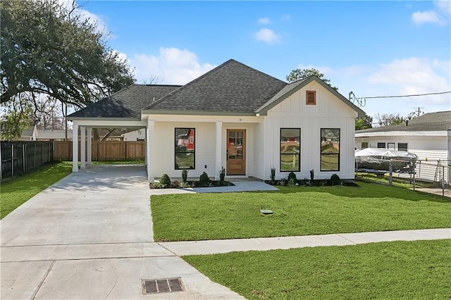 modern farmhouse style home with a front yard and a carport