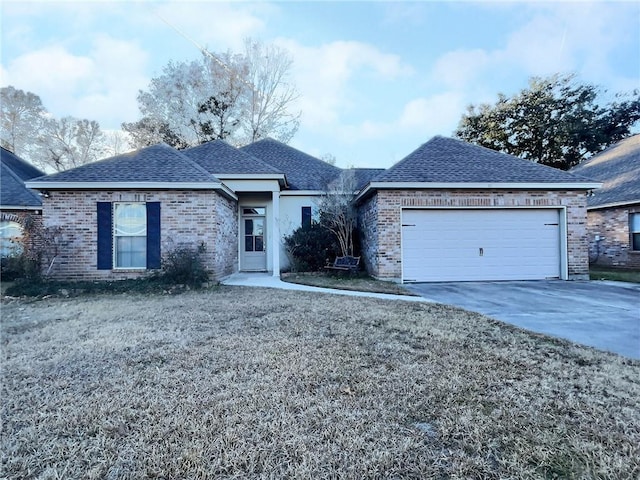 ranch-style home featuring brick siding, roof with shingles, and an attached garage