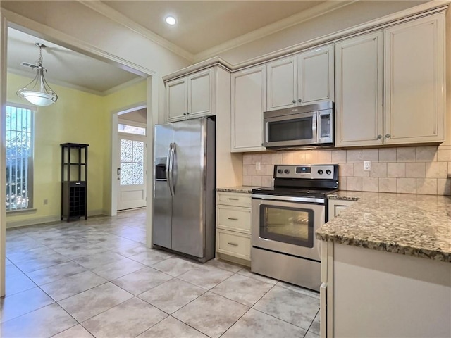 kitchen with decorative light fixtures, crown molding, decorative backsplash, appliances with stainless steel finishes, and light stone countertops