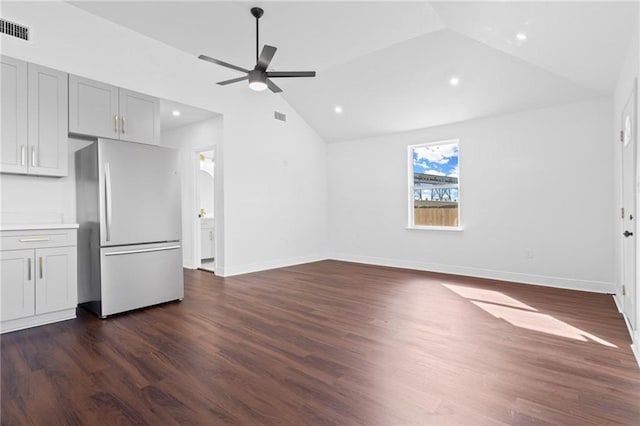 unfurnished living room featuring lofted ceiling, dark wood-type flooring, and ceiling fan