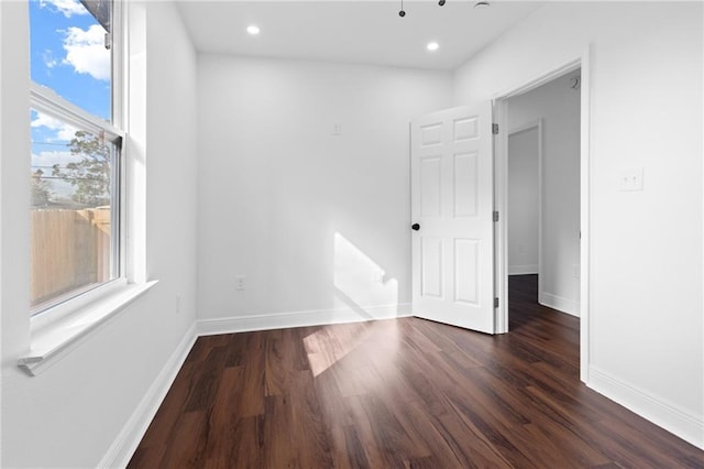 spare room featuring dark hardwood / wood-style floors