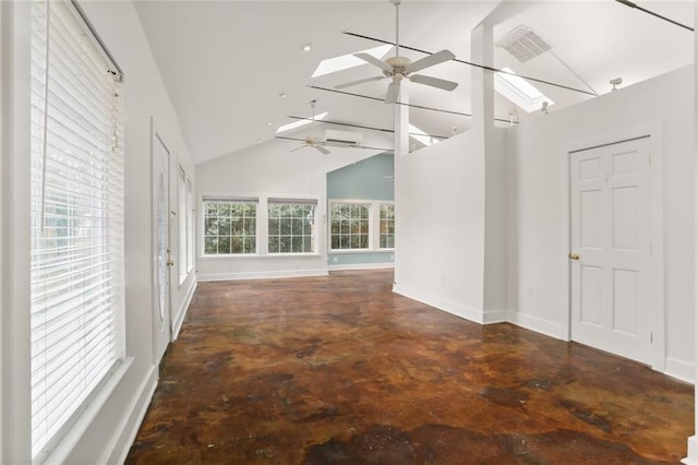 interior space featuring ceiling fan, a skylight, and high vaulted ceiling