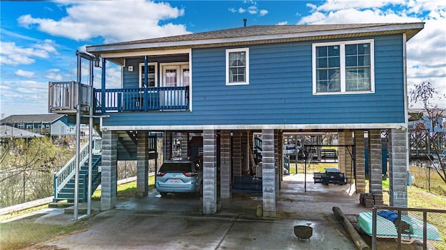 rear view of house with a carport and a balcony