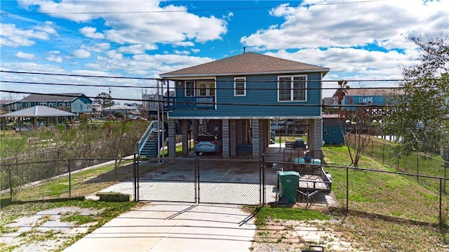 back of house featuring a carport and a balcony