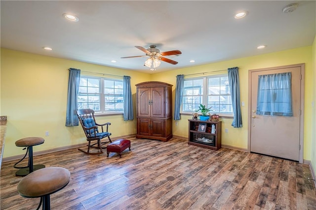 living area with ceiling fan and hardwood / wood-style floors