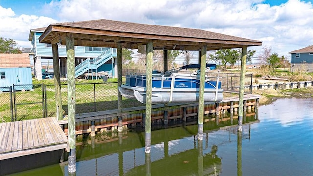 view of dock with a water view and a yard