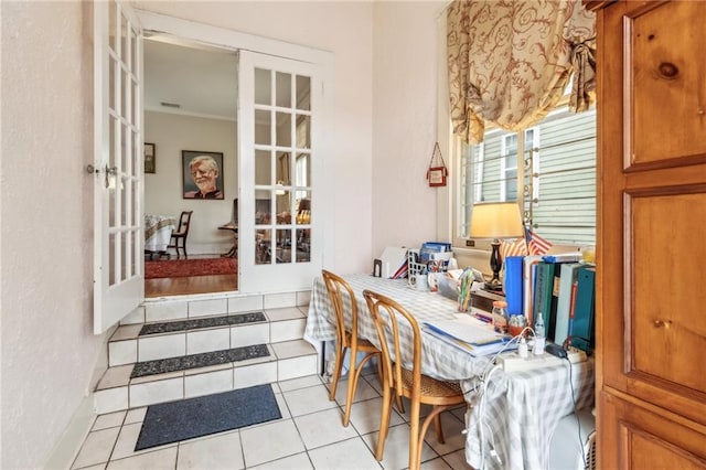 dining room featuring french doors and light tile patterned floors