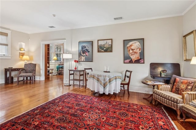 interior space with hardwood / wood-style flooring and ornamental molding