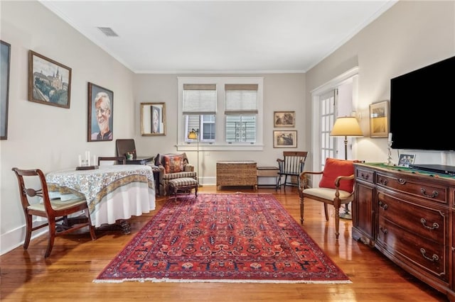 sitting room featuring crown molding and light hardwood / wood-style flooring