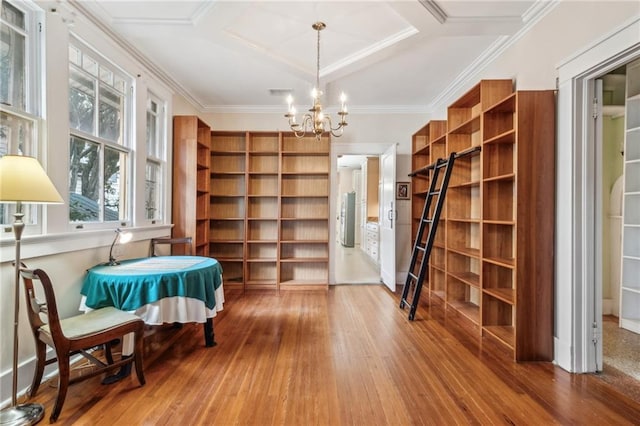 spacious closet featuring coffered ceiling, hardwood / wood-style floors, and a notable chandelier