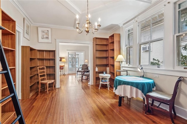 dining room with crown molding, wood-type flooring, and a notable chandelier