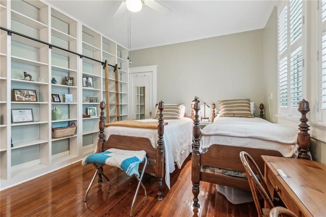 bedroom featuring hardwood / wood-style flooring, crown molding, and ceiling fan