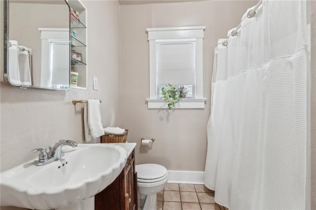 bathroom featuring tile patterned flooring, sink, and toilet