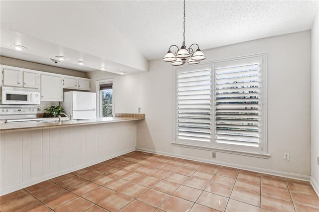 kitchen featuring vaulted ceiling, pendant lighting, white cabinetry, white appliances, and a textured ceiling