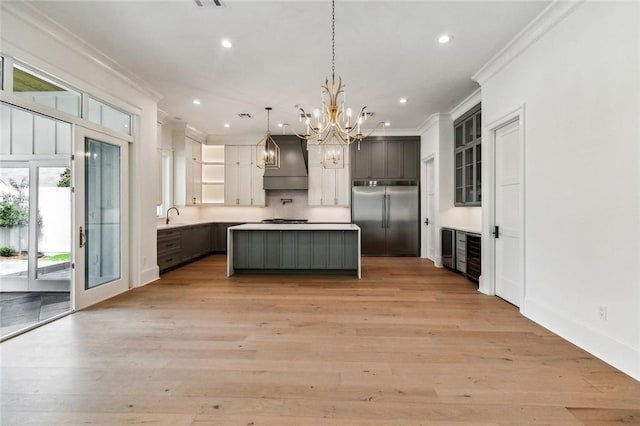 3705 Rue Emilion Dr, Metairie, LA 70002 - kitchen featuring stainless steel built in refrigerator, premium range hood, ornamental molding, open shelves, and a chandelier